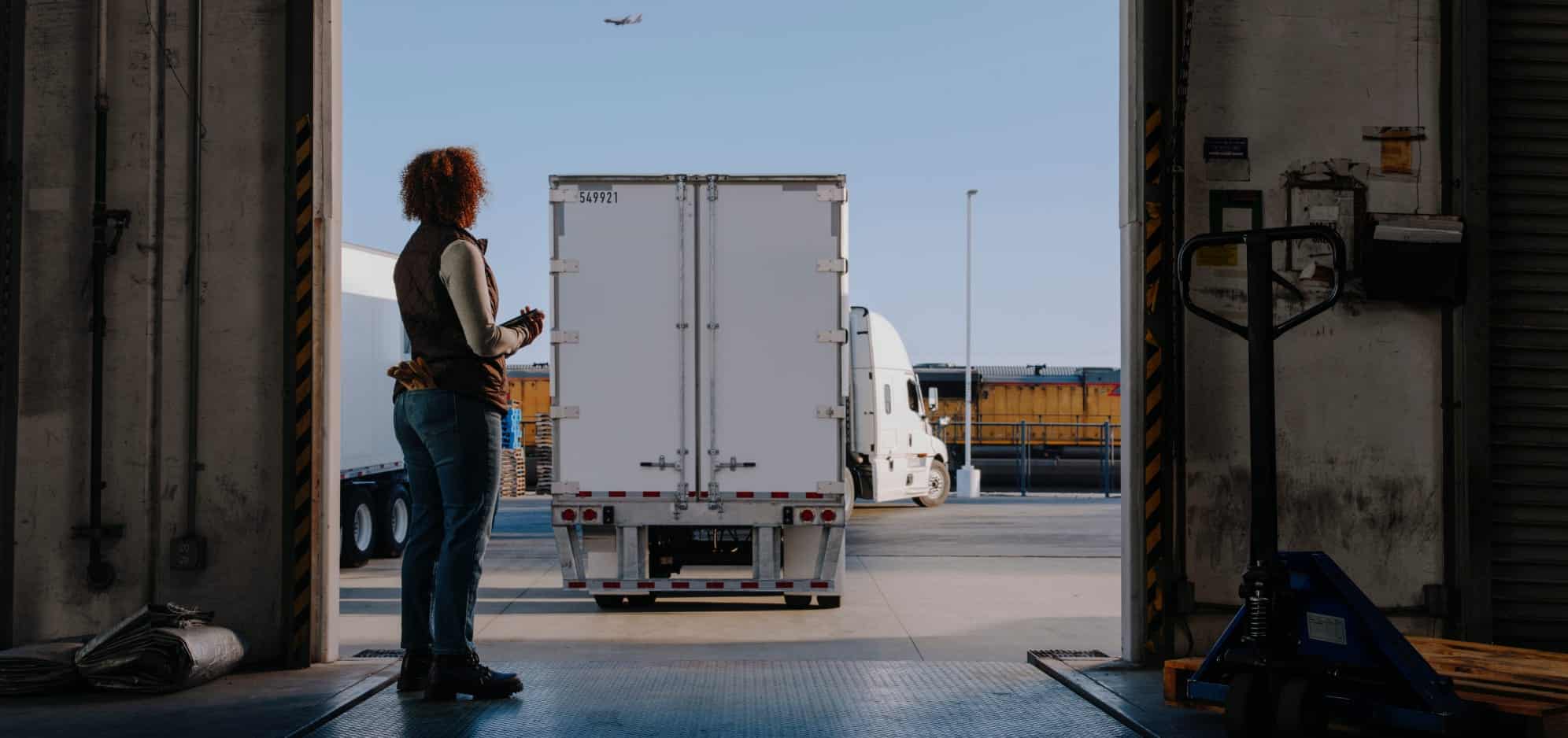 woman watching truck from loading dock