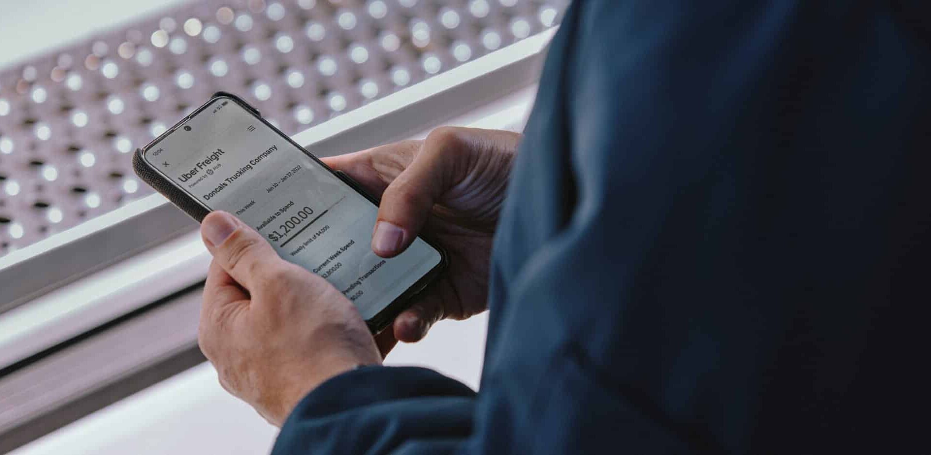 man looking at UF software on mobile device 