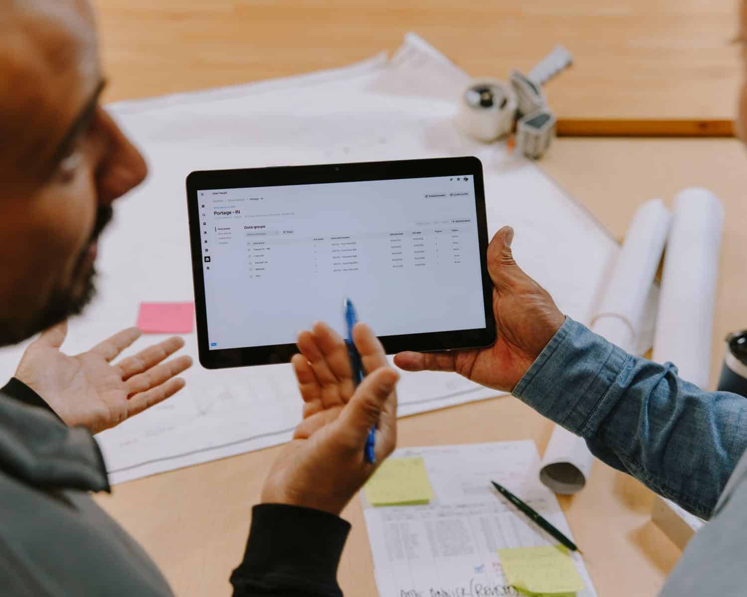 two men discussing ipad