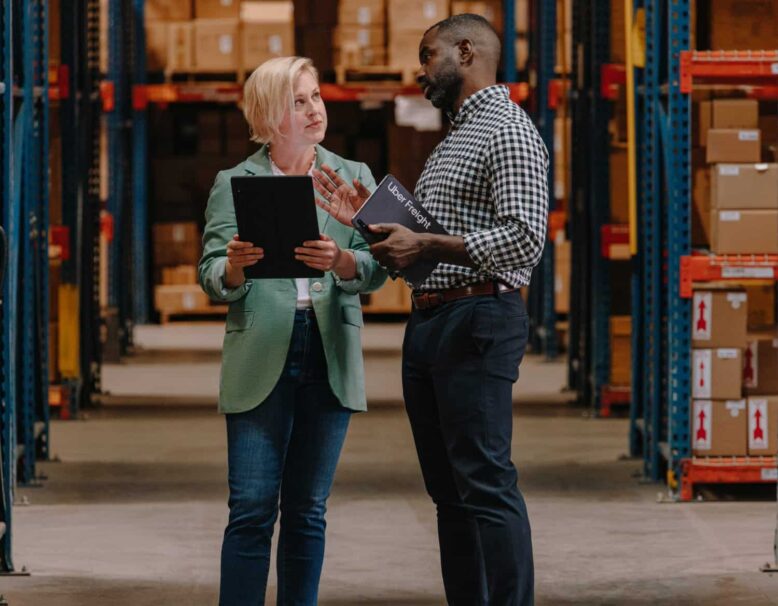 two people discussing something in warehouse