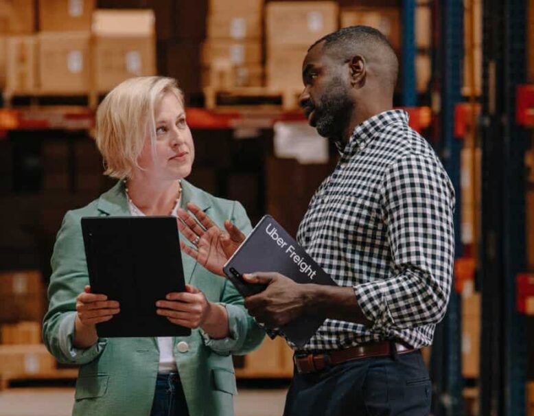 two people discussing something in warehouse