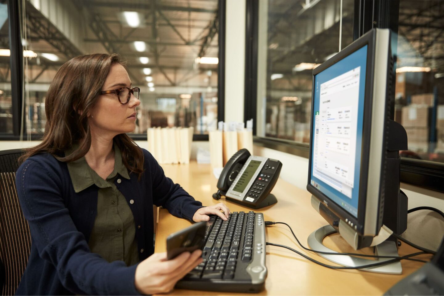 woman looking at computer at desk